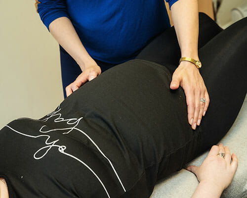 Dr Ros Drake providing prenatal chiropractic care to a pregnant patient