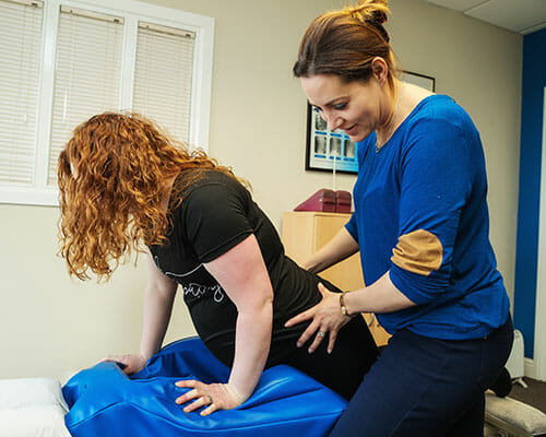 Dr Ros Drake providing prenatal chiropractic care to a pregnant patient at the clinic