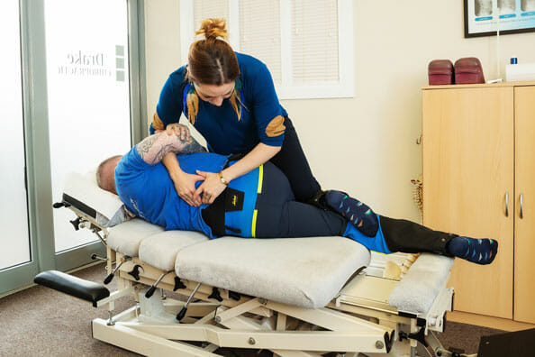 Dr Ros Drake providing chiropractic treatment to an athlete